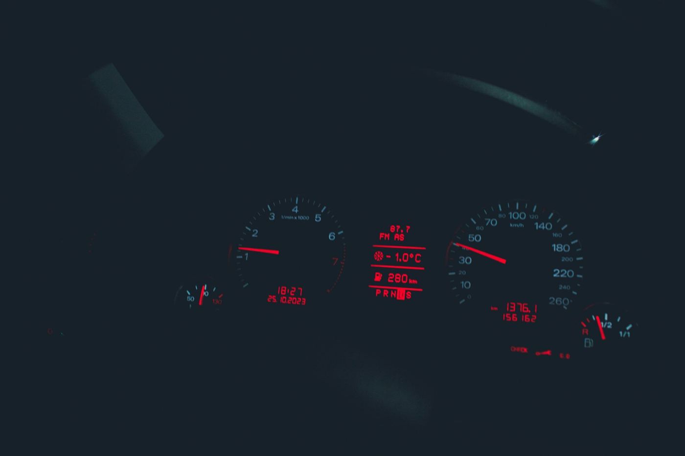 Car instrument cluster glowing at night